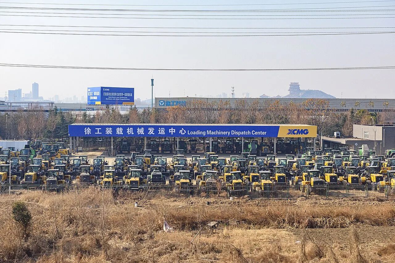 Rows of construction machines in front of the signed XCMG dispatch area.