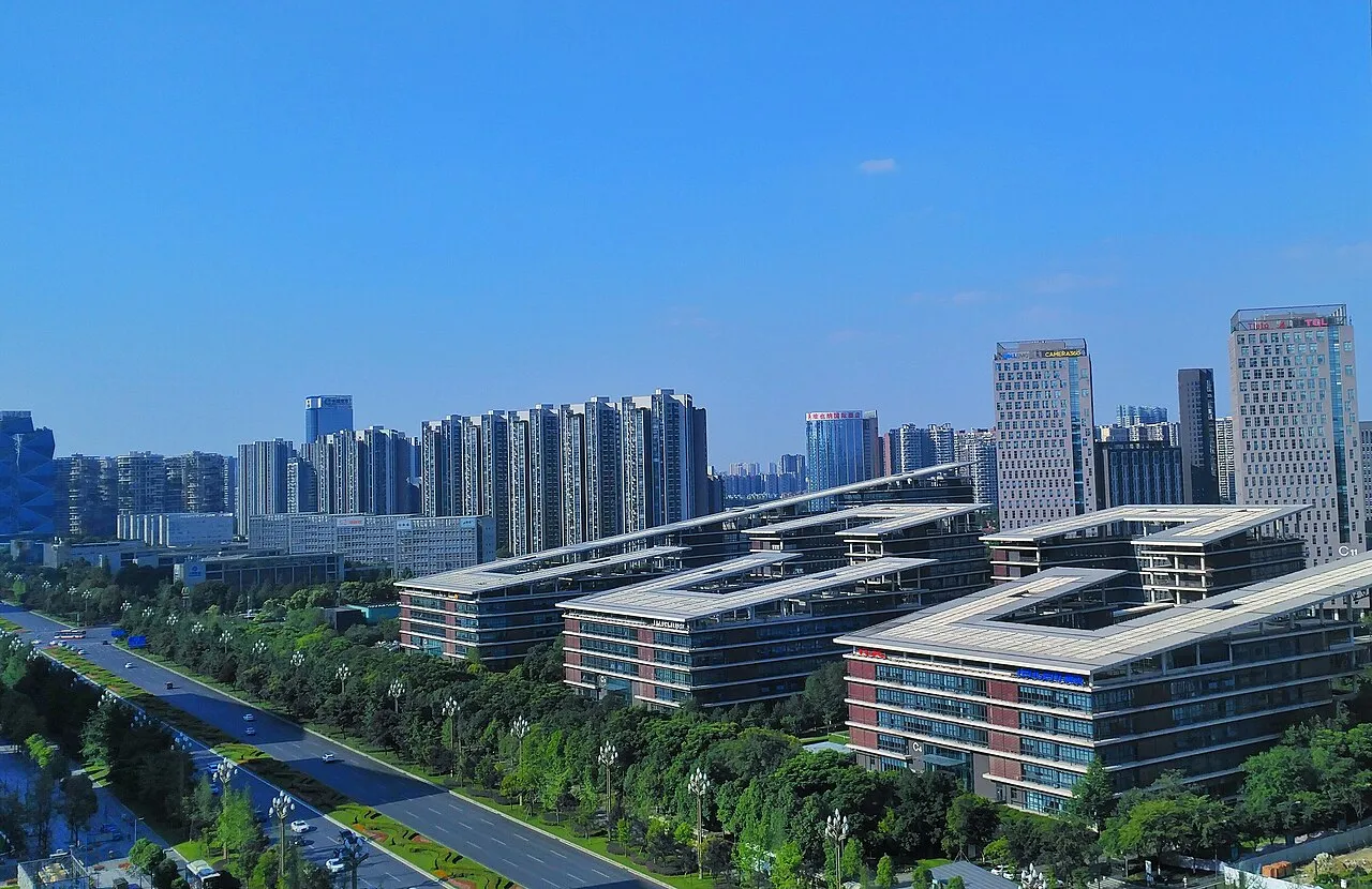 Office buildings with flat projecting roofs and tree-lined streets.