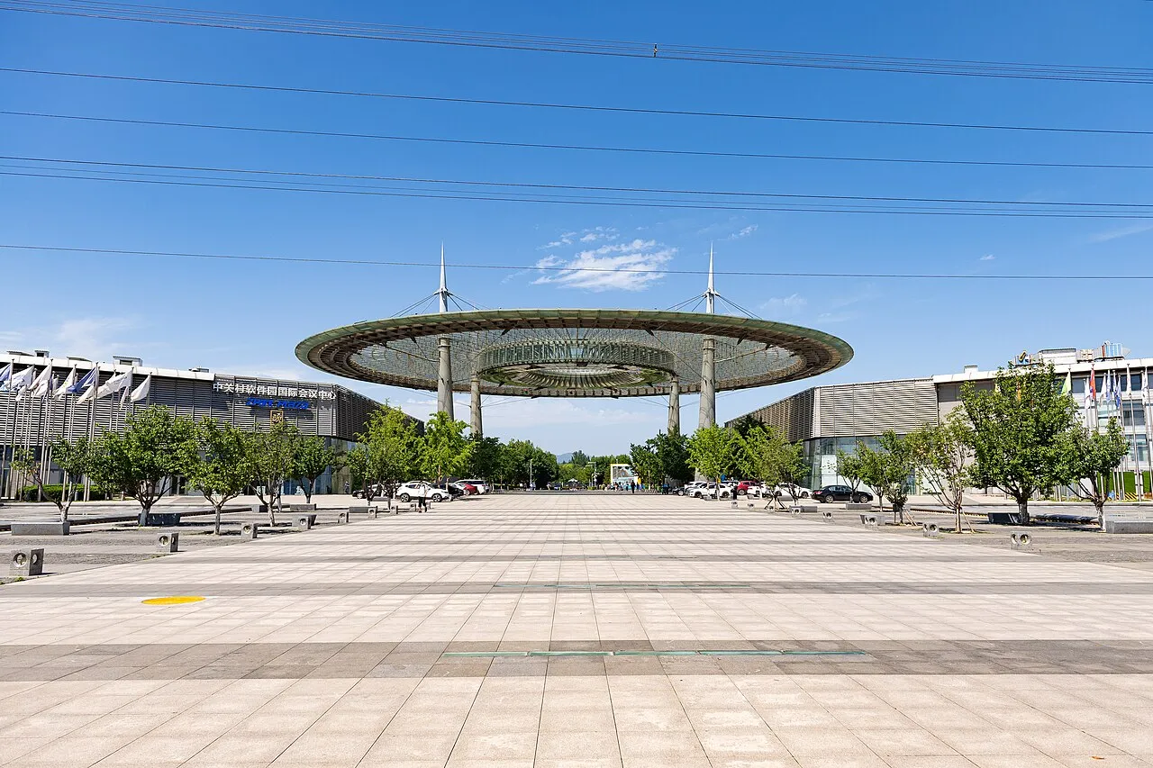 Wide plaza with a circular canopy and software park buildings.