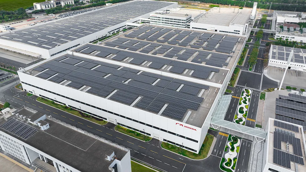 Aerial view of GAC Honda’s NEV factory with solar panels on the production hall roofs.